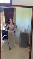 Woman takes mirror selfies in Karangasem room early morning