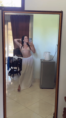 Woman takes mirror selfies in Karangasem room early morning