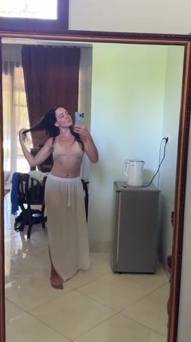 Woman takes mirror selfies in Karangasem room early morning