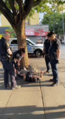 Four officers on a sidewalk, one person on the ground