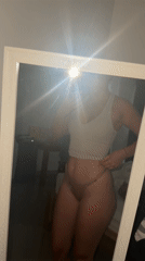 Woman takes mirror selfies in Dalung bedroom; Balinese offering spotted