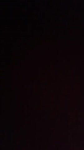 The media file is a very dark, blurry video clip. It appears to be taken in a low-light environment, possibly at night. There are no clearly identifiable subjects, objects, or scenes. The initial frames are almost completely black, with some faint, indistinct shapes appearing and disappearing. In the middle of the clip, a patch of very faint light appears on the right side, with some blurry, diagonal lines of light above it. The rest of the video remains extremely dark and indistinct, making it impossible to discern any specific details about the setting, activity, or emotions. There is no visible text. The location context provided is Кенжекул, Kyrgyzstan, but this information cannot be visually confirmed from the footage itself.