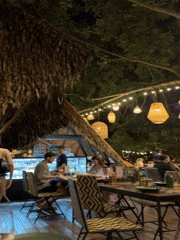 Evening diners gather at outdoor restaurant in Wichit, Thailand