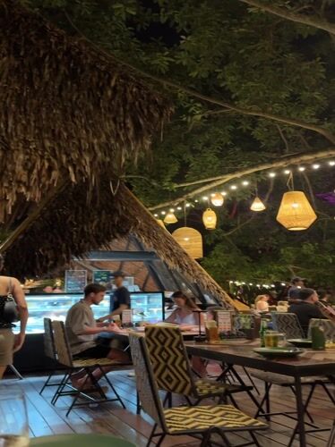 Evening diners gather at outdoor restaurant in Wichit, Thailand