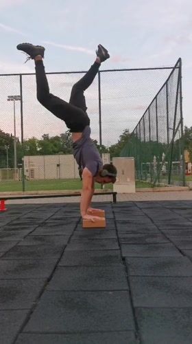 Man performs handstand workout at outdoor fitness park in Burgas