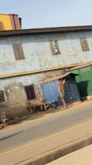 Seven men jog through urban Nigeria neighborhood