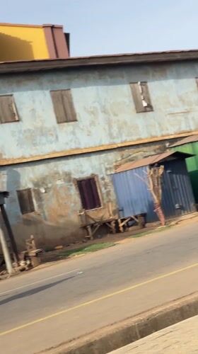 Seven men jog through urban Nigeria neighborhood