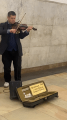 Formally dressed violinist busks in Moscow subway station