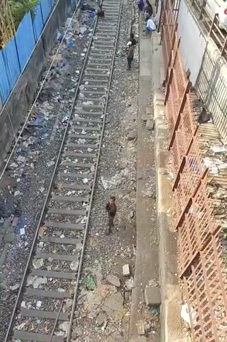 Mumbai railway corridors show urban density, waste accumulation
