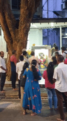 Devotees at a flower-draped Hindu shrine in Kuala Lumpur