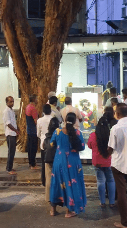 Devotees at a flower-draped Hindu shrine in Kuala Lumpur