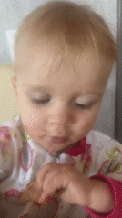 Baby Masha eating breakfast by sunny windowsill in Russia