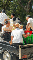 Men load supplies from pickup truck in Kuta Selatan