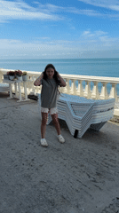 Girl performs headstands by seaside in Sochi, Russia