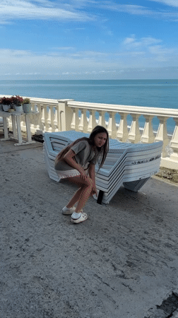 Girl performs headstands by seaside in Sochi, Russia
