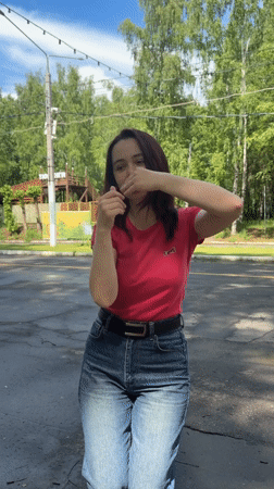 Woman dances while toddler eats flatbread in Izhevsk park