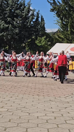 Traditional Bulgarian folk dancers perform in Markovo public space