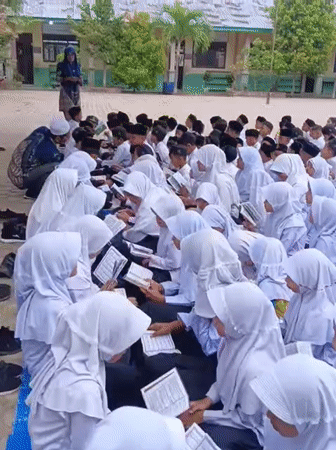 Students gather outdoors for religious activity in Baratpayaitek, Indonesia