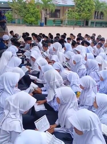 Students gather outdoors for religious activity in Baratpayaitek, Indonesia