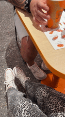 Two diners review menu at restaurant table in Budva