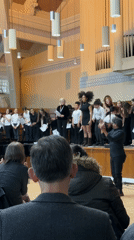 Choir performs and takes bows in London hall