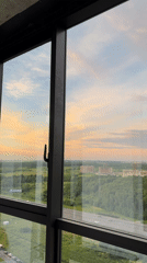 Suburban sunset viewed through a large window at golden hour