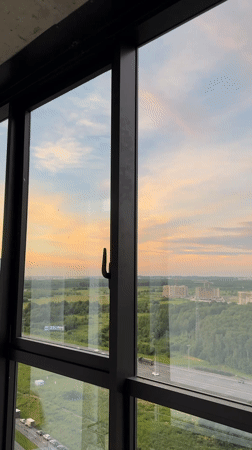 Suburban sunset through a window at golden hour