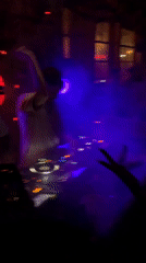 Tel Aviv nightclub in full swing, DJs and dancers under red lights