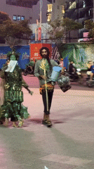 Nighttime scenes captured in Nha Trang: costumed figure, spinning Ferris wheel