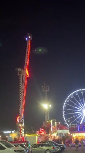 Neon-lit pendulum ride glows at a Varna amusement park