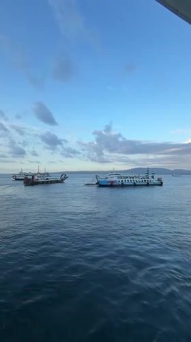 Morning ferry crossing at Ketapang port under dramatic skies