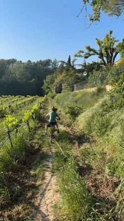 Boy rides red bike on dirt trail in Rousset