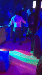 Evening club scene with dancing, live music, colorful lighting