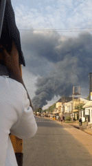Fire produces thick smoke in Nkpor, Nigeria street scene