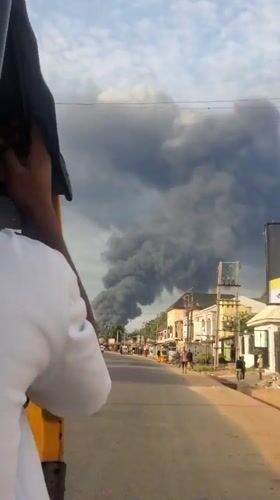 Fire produces thick smoke in Nkpor, Nigeria street scene
