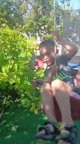 Kids at play in a Bulgarian backyard, summer morning