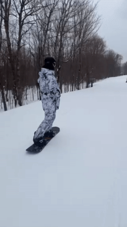 Snowboarder hits slopes at Jay Peak resort during cloudy evening