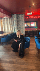 Woman poses for photos at Paris cafe Tuesday morning