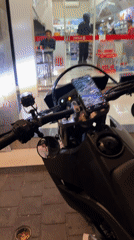 Motorcyclist takes selfie at Kuta convenience store