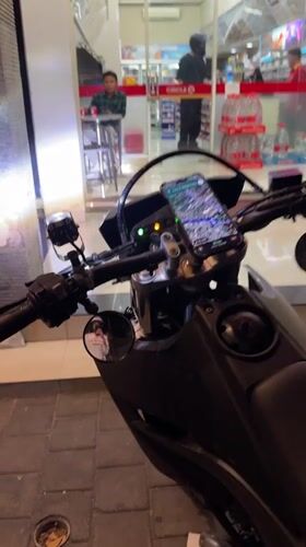 Motorcyclist takes selfie at Kuta convenience store