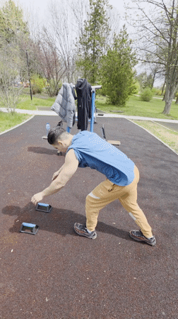 Man falls while attempting handstand at park exercise equipment
