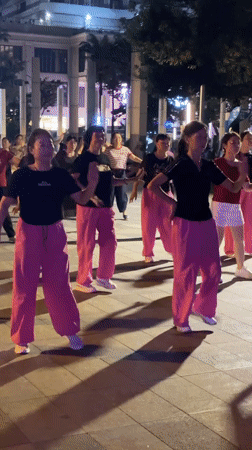 Outdoor dancing and a resting dog in Jiyang District