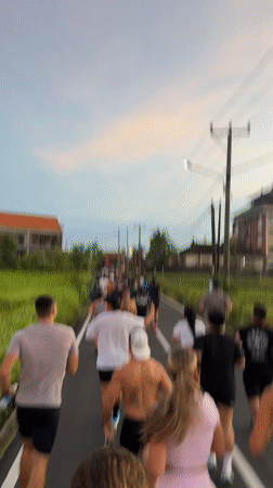 Group jog observed on narrow road in Cemagi, Indonesia