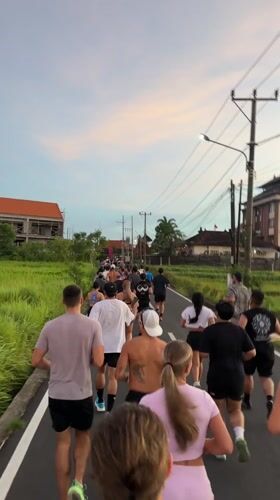 Group jog observed on narrow road in Cemagi, Indonesia