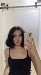 Woman takes mirror selfie in Ho Chi Minh City