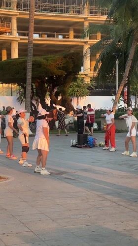 Evening exercise groups gather on Nha Trang beachfront promenade