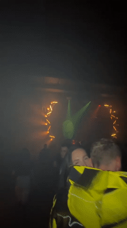 Smoky Moscow venue glows with circular orange and yellow stage lighting.