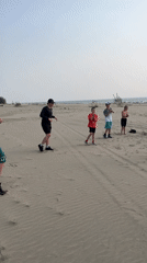 Beach stretching session on the sandy shores of Krasnoturansk