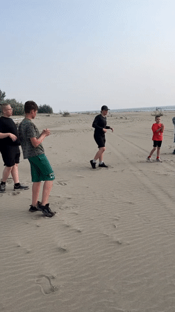 Beach stretching session on the sandy shores of Krasnoturansk