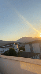 Fethiye balcony at golden hour, hills and rooftops at sunset